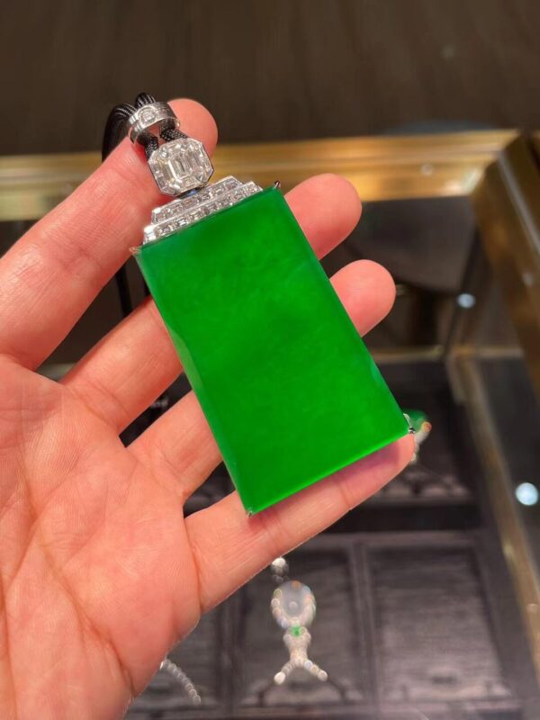 Rectangular emerald pendant with a solid green design